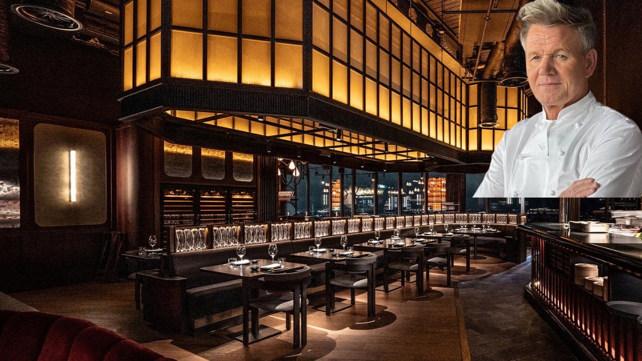 A chef in a white uniform stands proudly in front of a restaurant, showcasing culinary expertise and hospitality.