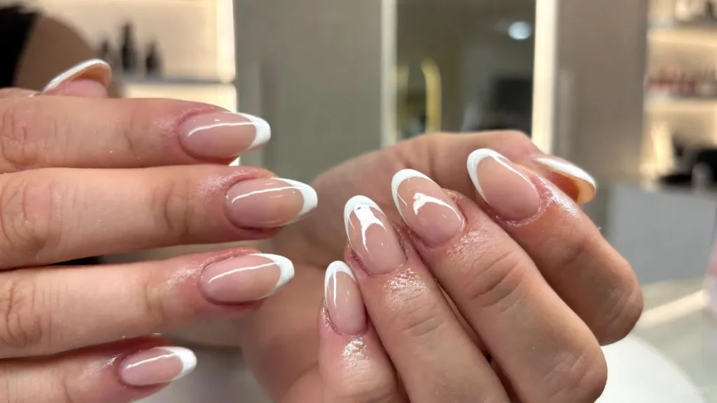 Ombre Gel X Nails with nude to pink gradient and minimal gold accents on manicured hands.