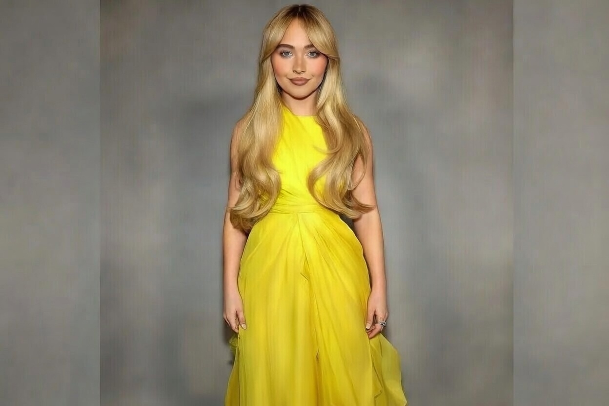 Woman in modest yellow dress, fully covered, no face visible.